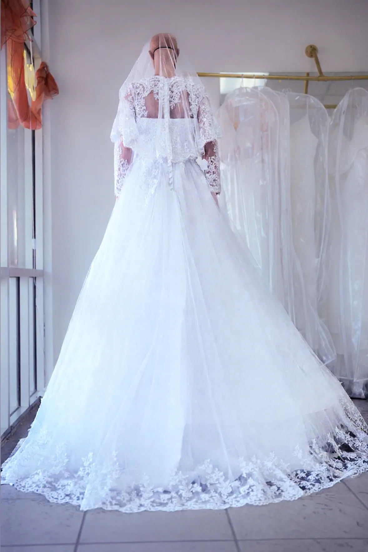 White illusion-sleeve lace wedding gown photo 5