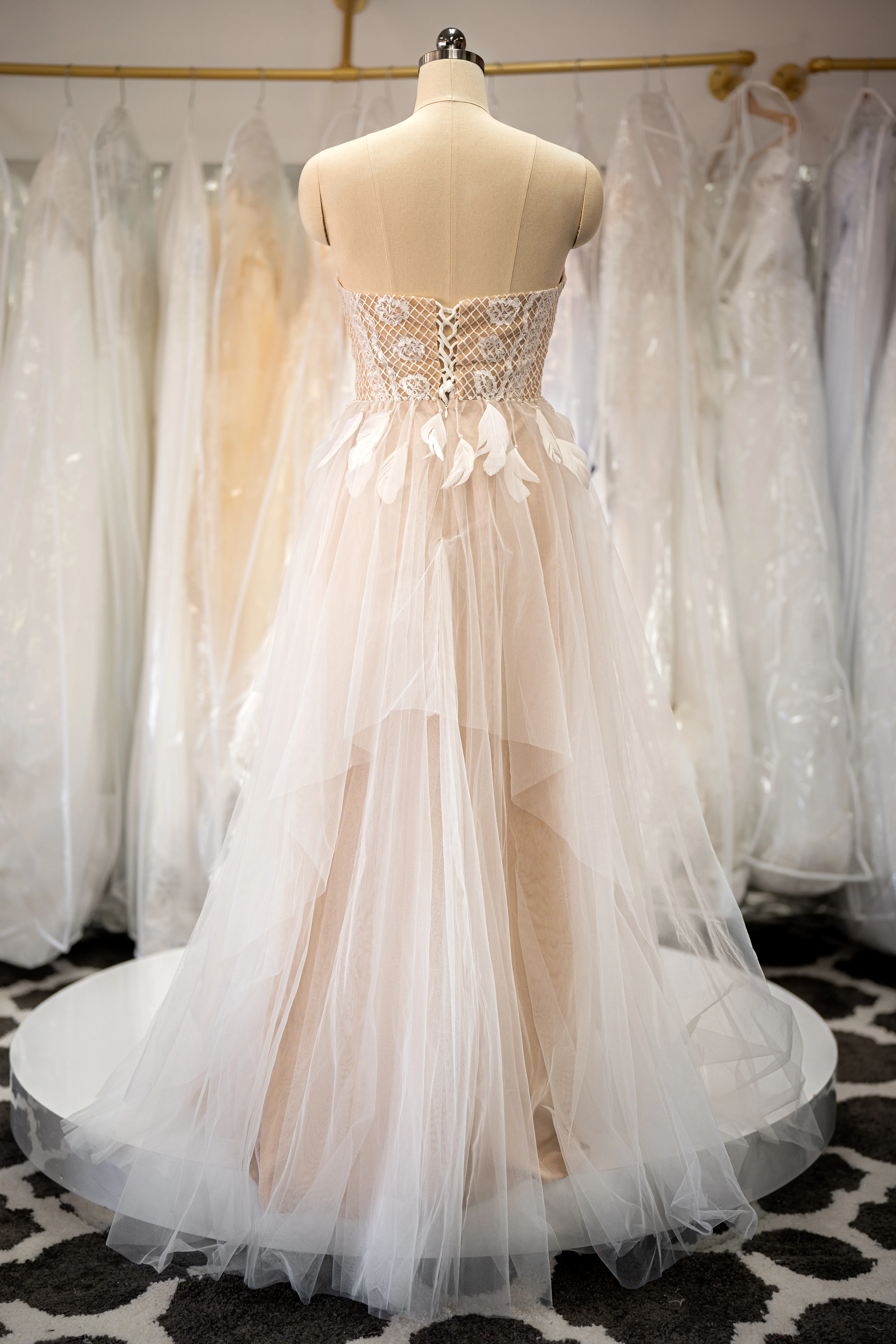 Ivory lace gown with feather accents photo 2