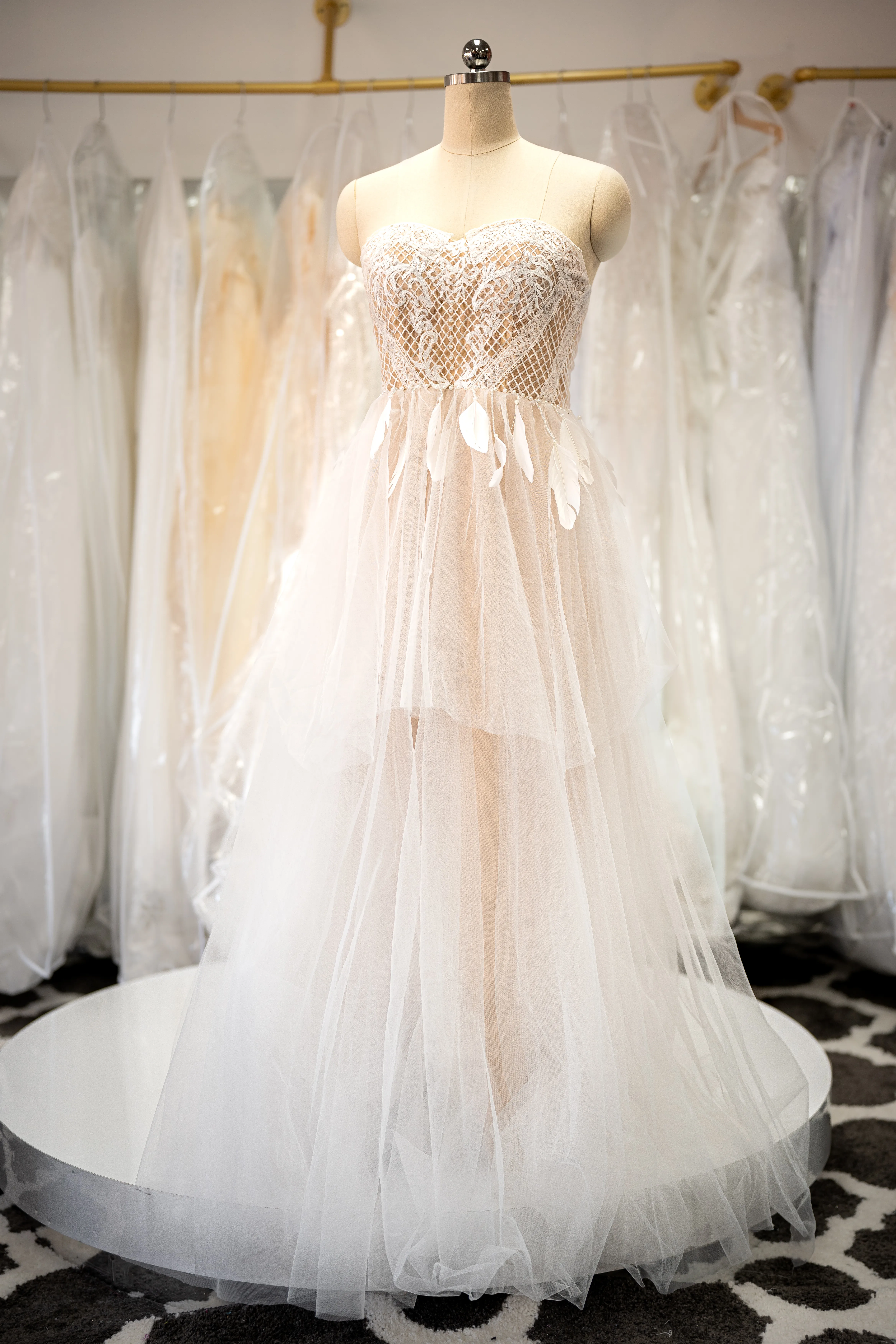 Ivory lace gown with feather accents