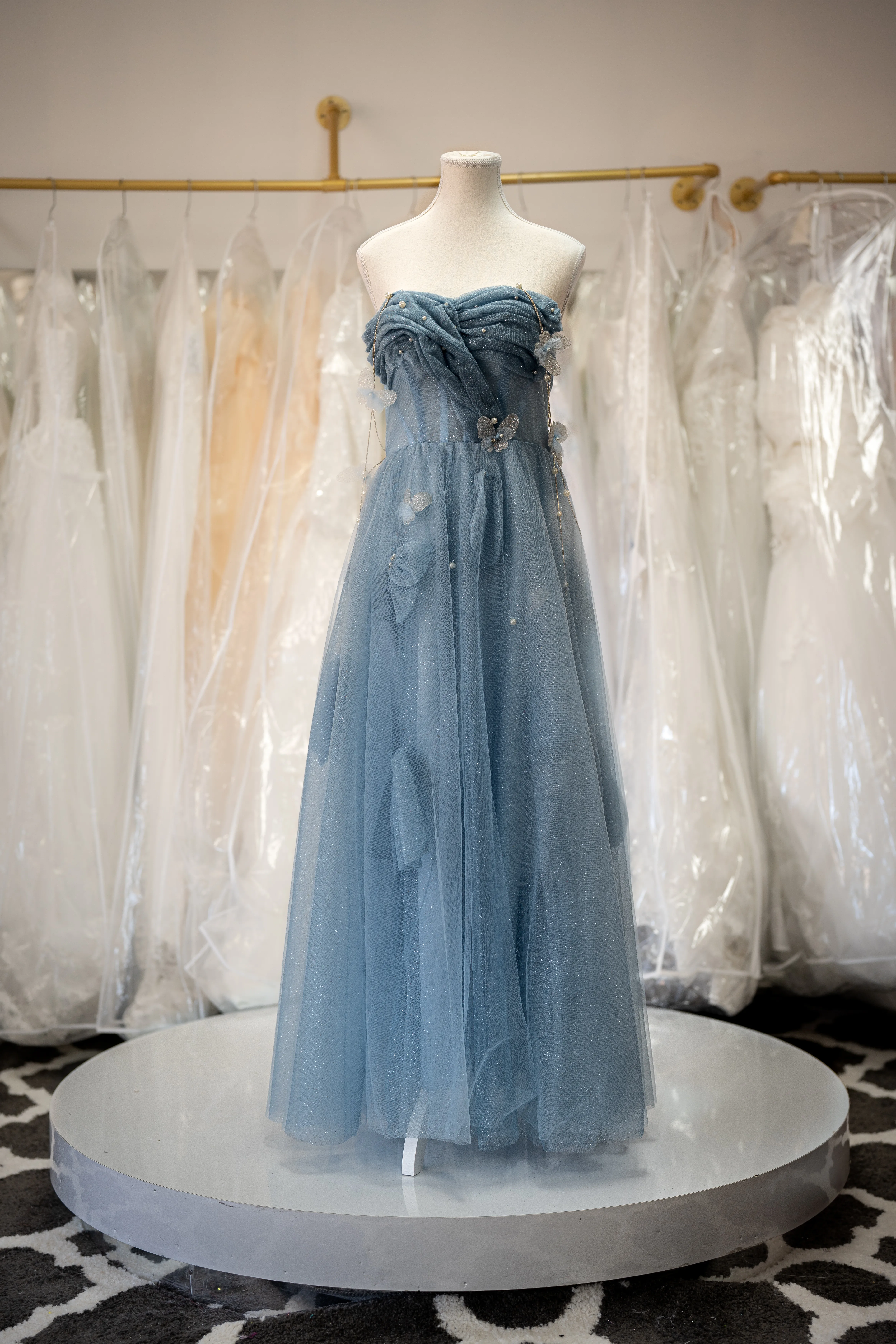 Dusty blue tulle gown with butterfly appliqués